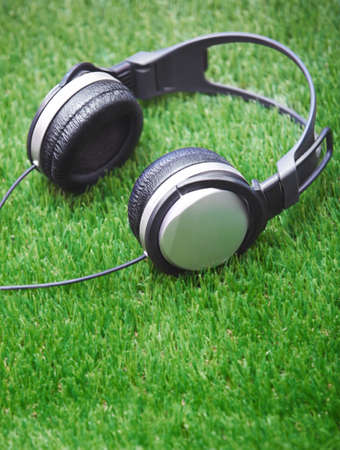 Headphones in a grass. Vertical photoの写真素材