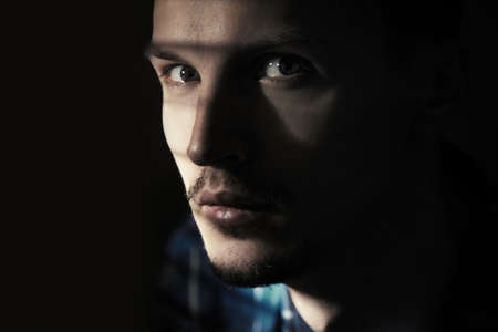 Illegal man in the dark prison. Close-up portraitの写真素材