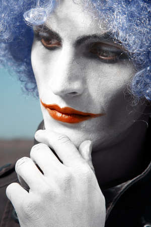 Pensive clown with blue wig. Vertical colorful portraitの写真素材