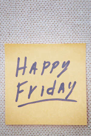 Adhesive note with Happy Friday text on a cork bulletin boardの写真素材