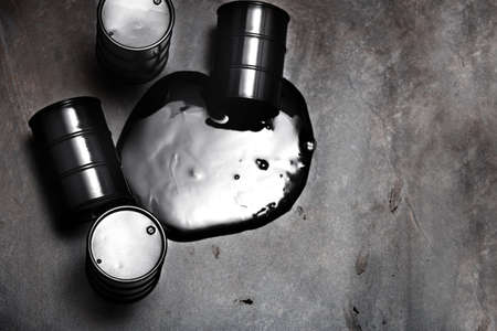High angle view on four fuel drums with spilled oilの写真素材