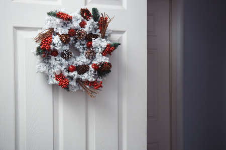 White door with Christmas wreath. Horizontal photoの写真素材