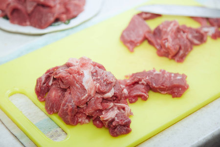 Raw meat sliced on a kitchen table. Close-up viewの写真素材
