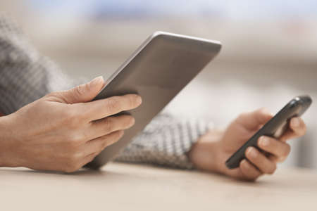 Businesswoman at office with digital tablet and smartphone
