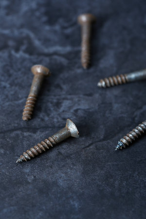 Group of rusty screws. Close-up vertical photoの写真素材