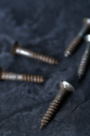 Group of rusty screws. Close-up vertical photoの写真素材