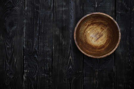 Empty wooden bowl on a vintage tableの写真素材