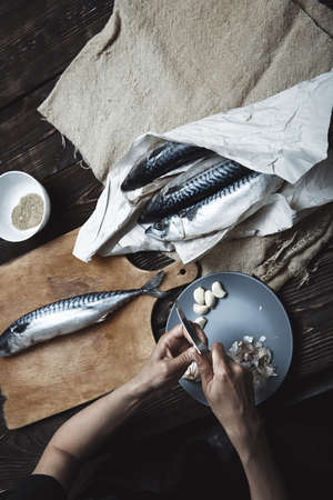 Woman preparing fishの写真素材