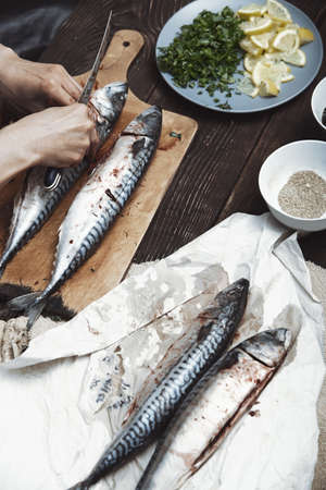 Woman preparing mackerel fishの写真素材