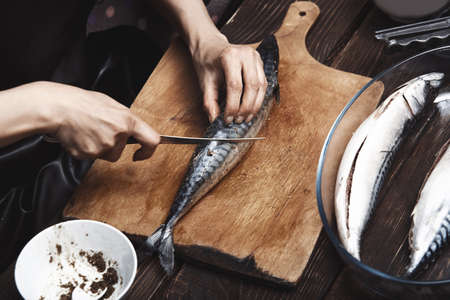 Woman preparing mackerel fishの写真素材