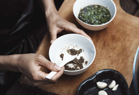 Woman preparing Indian sauce for vegetarian foodの写真素材