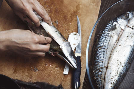 Woman preparing mackerel fishの写真素材