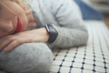 Woman sleeping with smart watchの写真素材