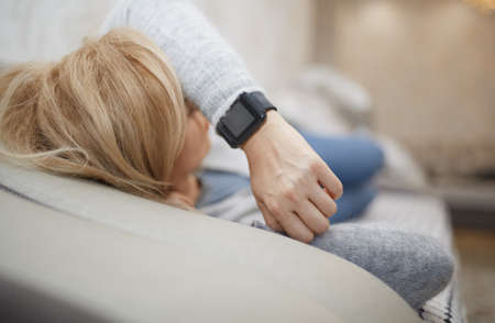 Woman sleeping with smart watchの写真素材