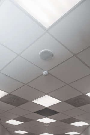 Office room ceiling with smoke detector and alarmの写真素材