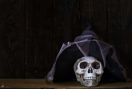 Human skull with magician hat at the wooden wallの写真素材