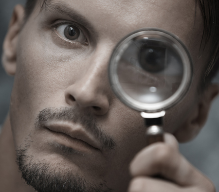 Man with magnifying glass. Horizontal portraitの写真素材