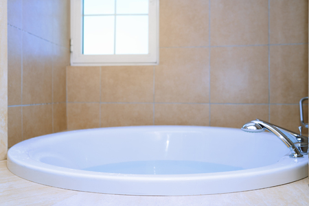 Modern bathtub full of waterの写真素材