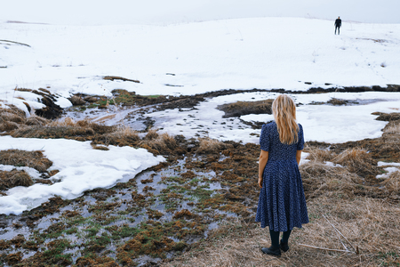 Woman and man in the winter landscape with marshy puddleの写真素材