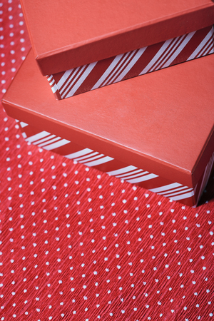 Christmas gift boxes on a red wrapping paperの写真素材