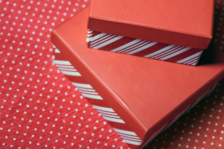 Christmas gift boxes on a red wrapping paperの写真素材