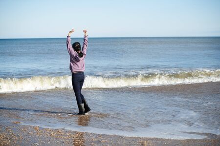 Happy woman having fun at the oceanの写真素材