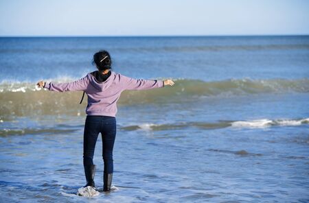 Happy woman having fun at the oceanの写真素材