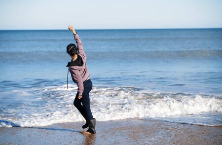 Happy woman having fun at the oceanの写真素材