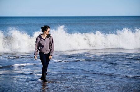 Happy woman having fun at the oceanの写真素材