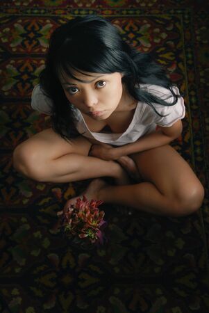 Sensual photo of the lady sitting on the carpetの写真素材