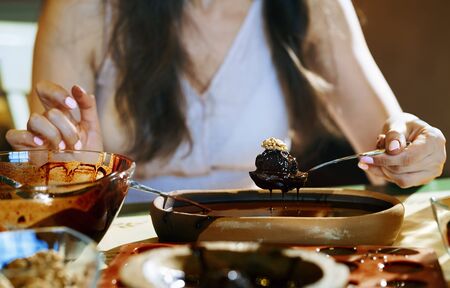Staying at home woman preparing handmade vegetarian chocolate trufflesの写真素材