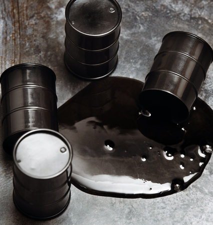 High angle view on four fuel drums with spilled oilの写真素材