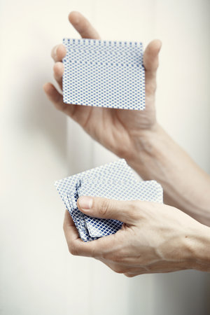 Hand of dealer shuffling deck of cardsの写真素材