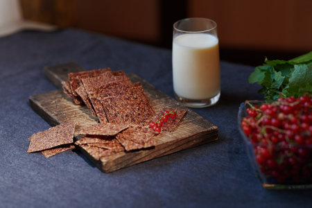 Vegan flaxseed bread with berries next to the glass with coconut milkの写真素材
