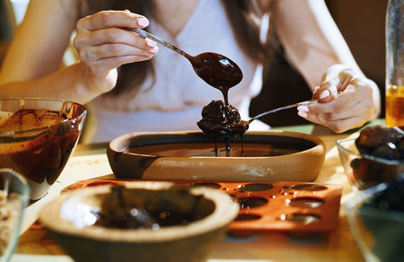 Staying at home woman preparing handmade vegetarian chocolate trufflesの写真素材