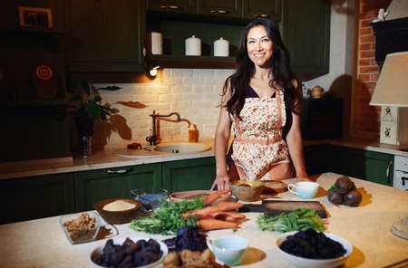 Staying at home woman preparing and cooking vegetarian foodの写真素材