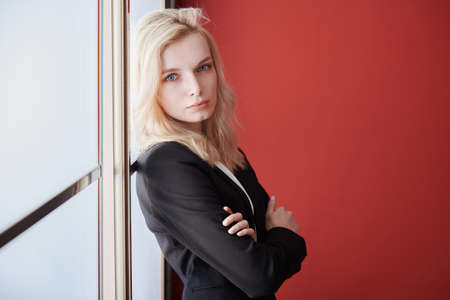 Young adult business woman standing next to the windowの写真素材