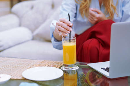Woman relaxing at the hotel lobby and blogging via laptopの写真素材