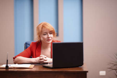 Businesswoman working on laptop at the officeの写真素材