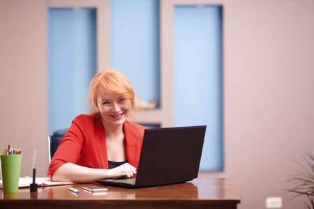 Businesswoman working on laptop at the officeの写真素材