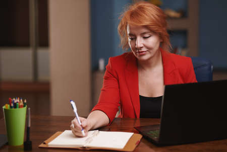 Businesswoman working on laptop at the officeの写真素材