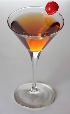Manhattan cocktail on gray background in martini glassの写真素材