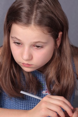 Teenage girl 12-13 years old doing homeworkの写真素材