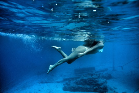 The girl dives underwater 2