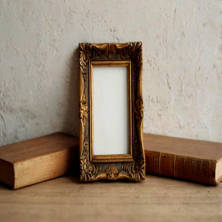 Vintage photo frame with books on a wooden table. Copy space.の写真素材
