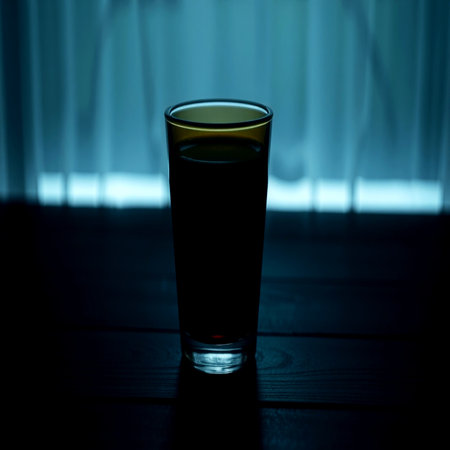 A glass of water on a dark wooden tableの写真素材