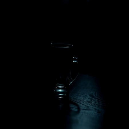 Empty cup of coffee on black background. Shallow depth of field.の写真素材
