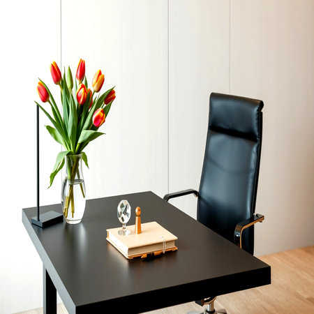 Interior of a modern office with a black leather chair and a vase of tulipsの写真素材