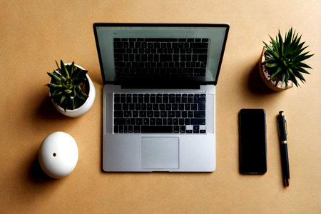 Laptop, phone and succulent plant on brown background. Top view