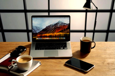 Laptop and coffee cup on wooden table in coffee shop, stock photo